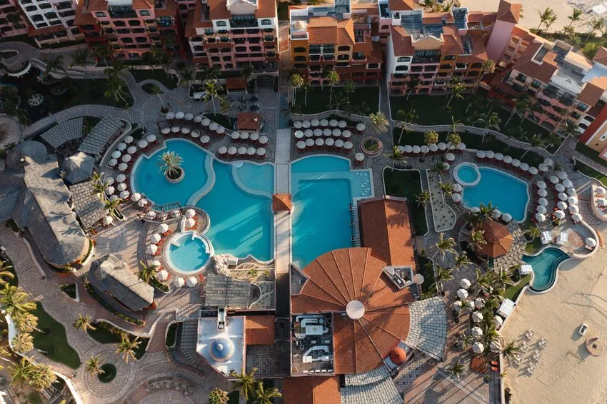 Aerial over the resort pools in late afternoon