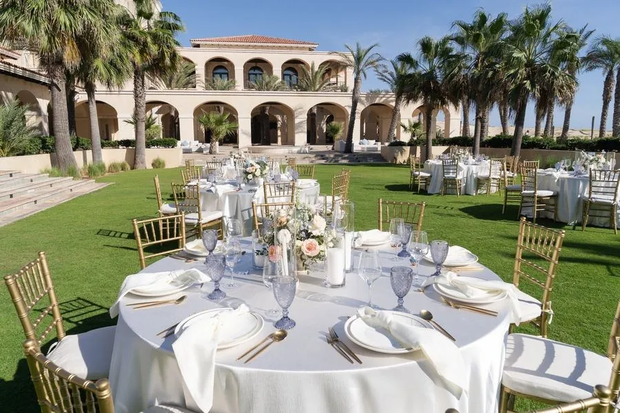 A wedding reception table set on a resort lawn